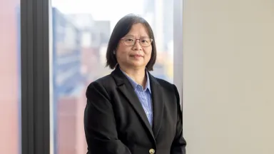 Headshot of Hiu Lam Choy, PhD Associate Professor, Accounting standing in front of window