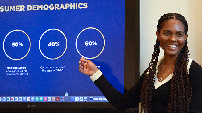 Allaiyah Bartley points at screen during presentation.