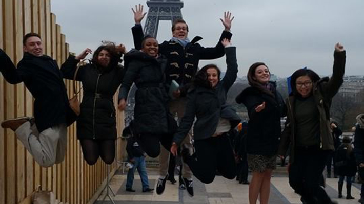Students jumping on the air in front of the Eiffel Tower