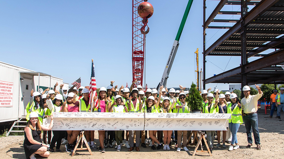 NAIOP students with signed building beam at construction site