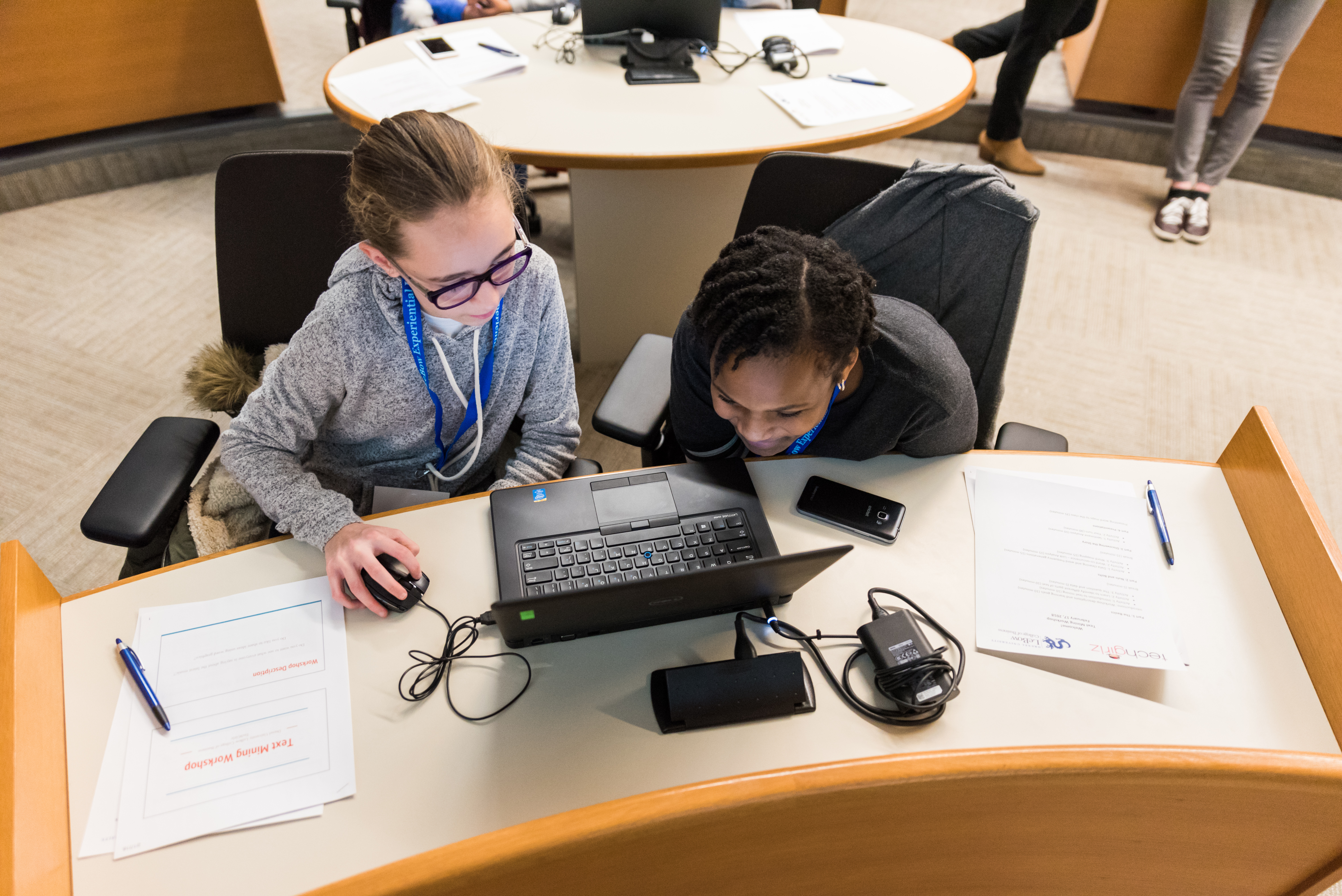 Two young girls looking at a computer