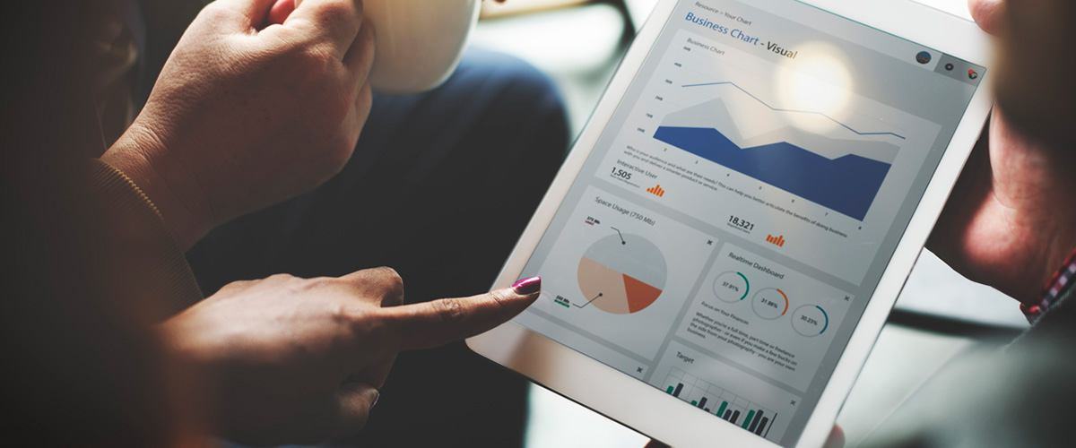 people reviewing business analytics on a tablet