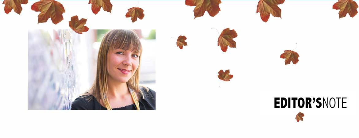 smiling student with leaves falling around them
