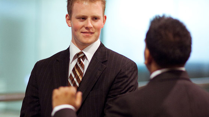 Student talking to faculty member