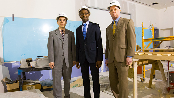 faculty pose wearing hardhats