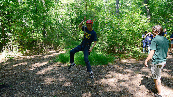 students using rope course during event