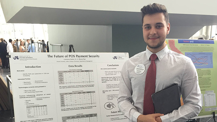 Student in front of presentation Student in front of presentation