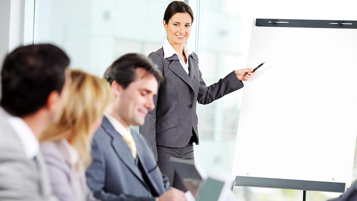 board woman points to flipchart