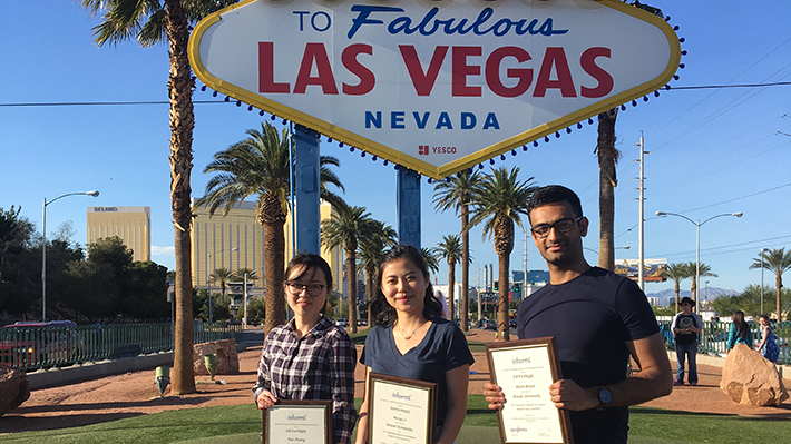 Arjun Arora, Hong Li and Ran Zhang in front of Las Vegas sign