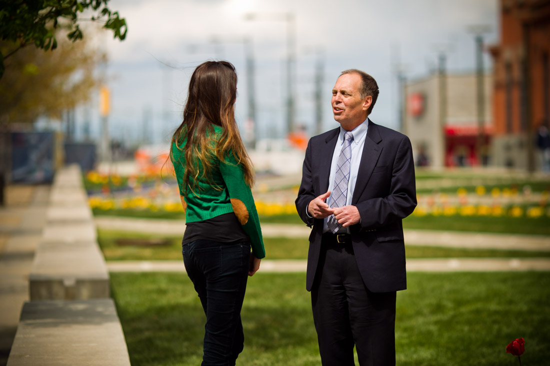 Dean Frank Linnehan talking with student on campus