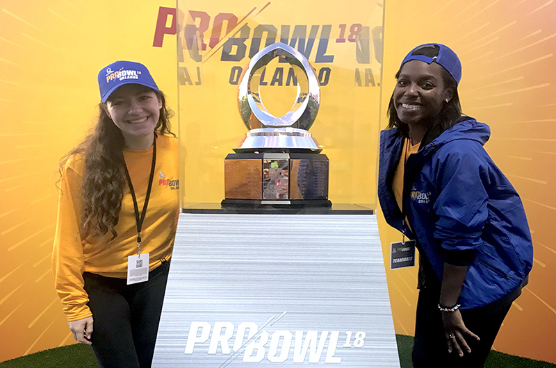 Samantha Bickel, left, and Kamille Watson, right, with the Pro Bowl trophy.