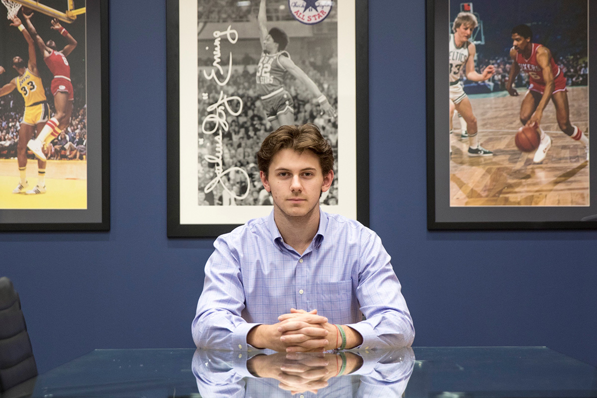 Alex Norcross poses in 76ers Office