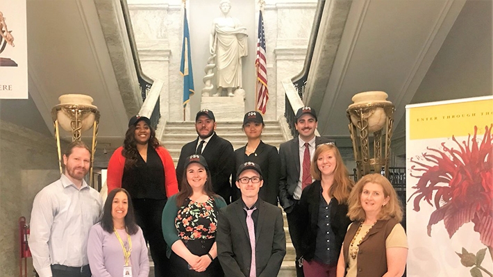 Accounting Students Pose in Front of Statue at Mutter Museum