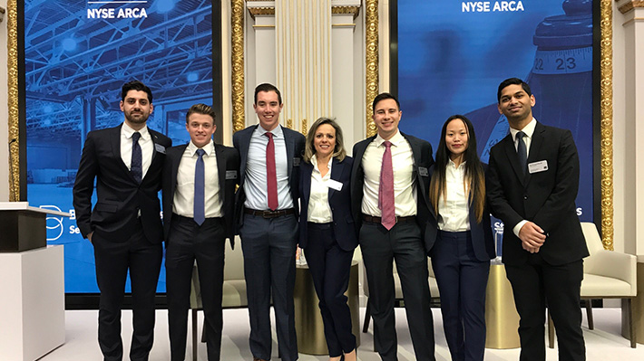 NYSE students pose after presentation