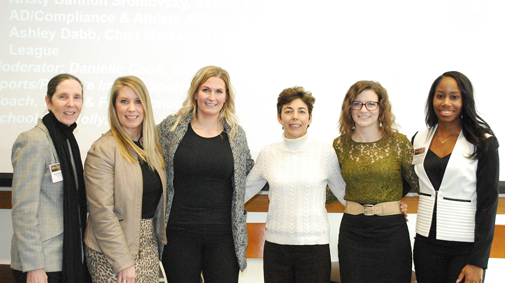 Panelists, faculty and students pose for photo post conference