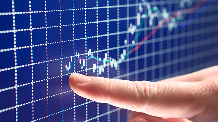 Finger following rising stock price on screen Finger following rising stock price on screen