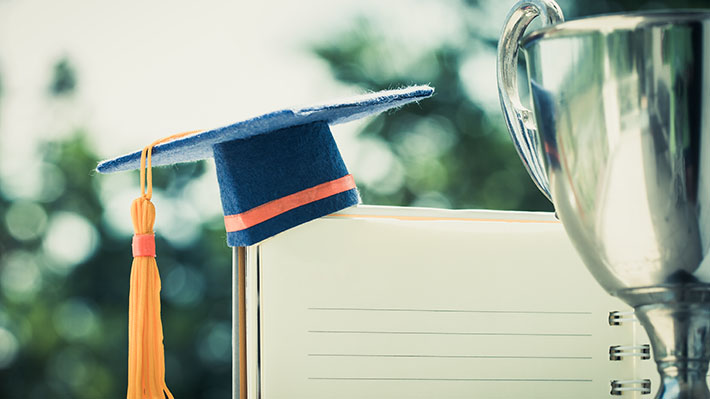 Notebook and trophy on a desk