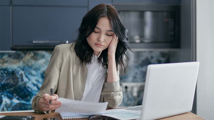 Women seated at laptop computer looking frustrated