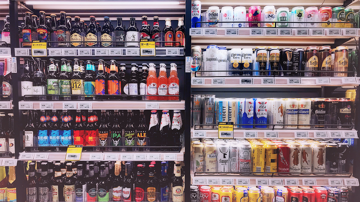 Beer and other beverages arranged in a refrigerated section of a store