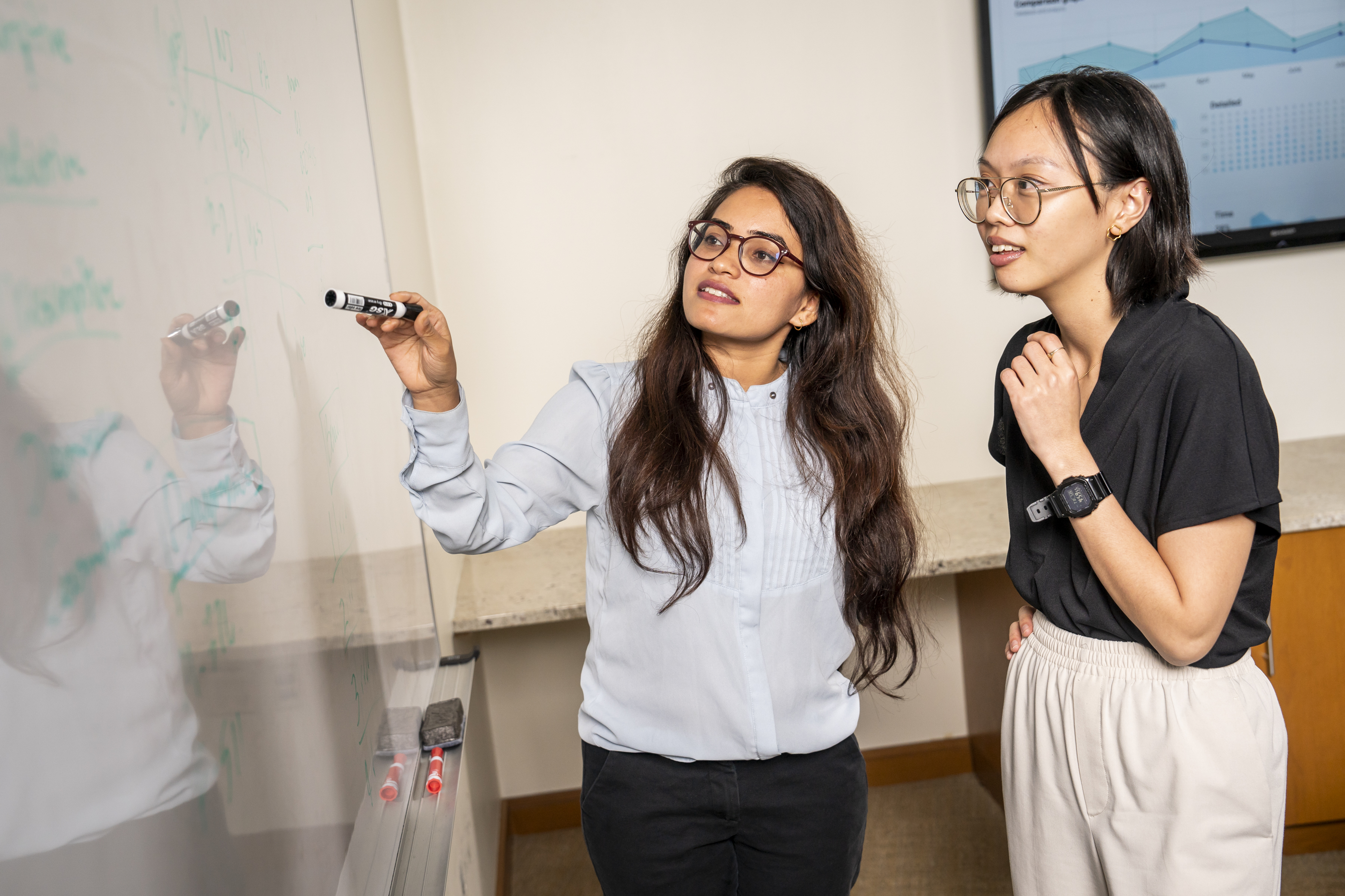 LeBow students working on the whiteboard