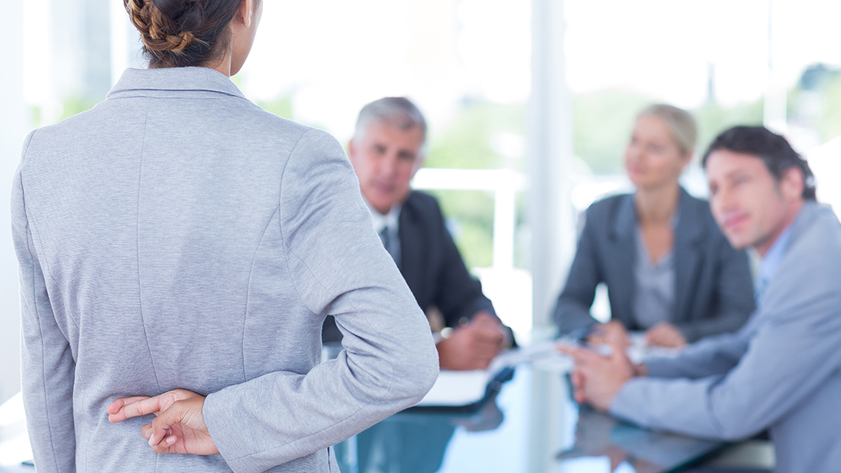 Businesswoman with fingers crossed behind her back