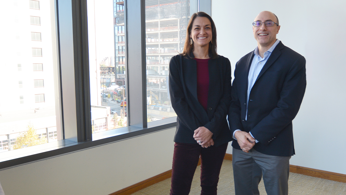 LeBow management professors Mary Mawritz, PhD, and Christian Resick, PhD A woman wearing a red shirt and a navy blazer standing next to a man with glasses wearing a light blue shirt and navy suit jacket