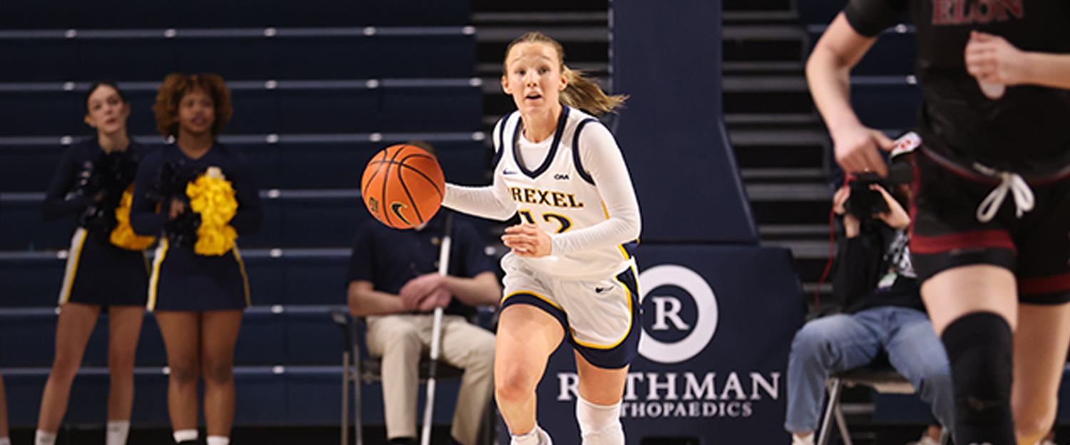 A young woman playing basketball wearing a white jersey
