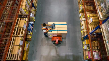 Worker using a laptop in a warehouse