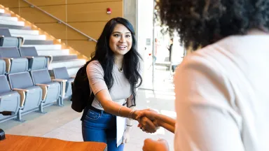 Business student introducing herself to a professor