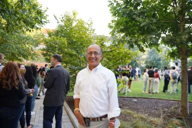 Dean Vibhas Madan smiling outside of GHall