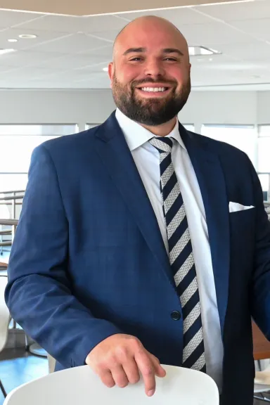 Man wearing blue suit and striped tie