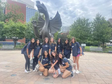 Camp Business Students Posing with the Dragon
