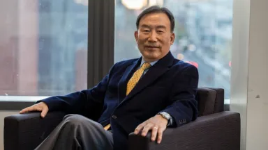 Headshot of Seung-Lae Kim, PhD, Professor of Decision Sciences & MIS sitting in chair in front of window