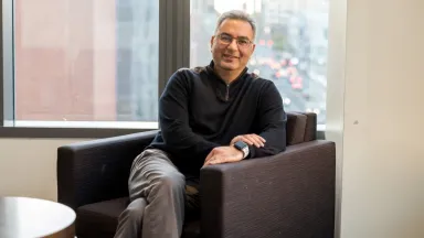 Headshot of Daniel Tzabbar, PhD, Professor of Management sitting in chair in front of window