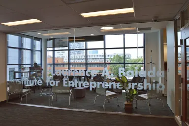 Students viewed through the glass wall entryway to the Baiada Institute for Entrepreneurship 
