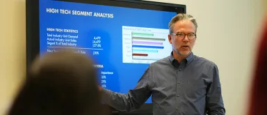 An EMBA student presents data to his peers during an on-campus session