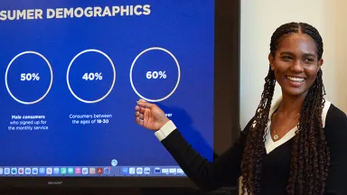 Allaiyah Bartley points at screen during presentation.
