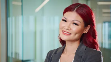 A woman with red hair in business attire