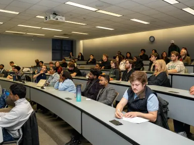 Individuals sitting in a lecture hall