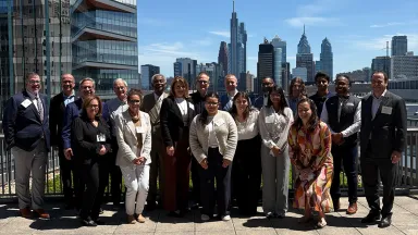 Dean's Advisory Board members pose with the Philadelphia skyline in the background.