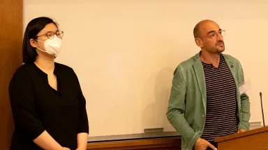 A woman and a man giving a presentation indoors