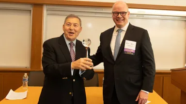 George Tsetsekos receiving his award in a classroom setting