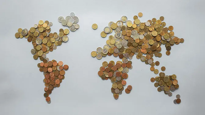 World map illustrated with coins