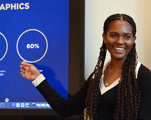 Allaiyah Bartley points at screen during presentation.