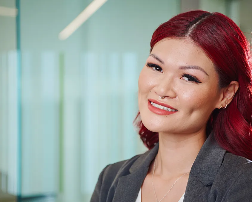 A woman with red hair in business attire