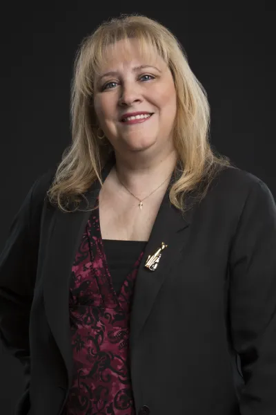 Blonde woman smiling in black blazer