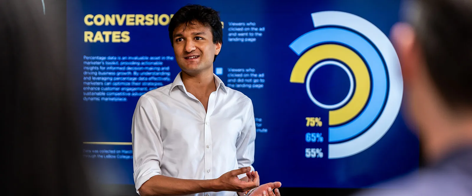 a drexel lebow MBA student presents data to a group of industry leaders during an experiential learning opportunity