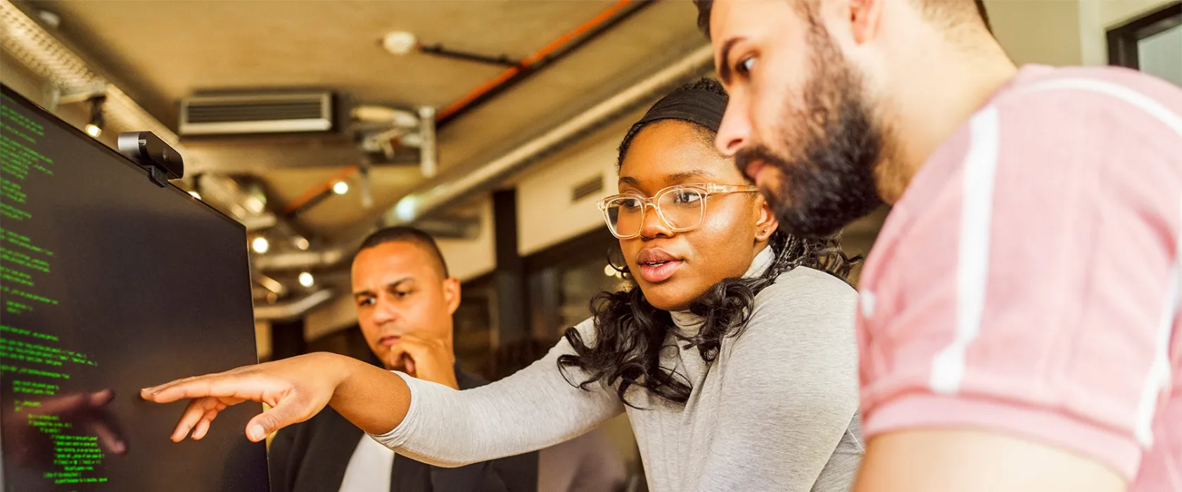 Students working together in at a computer.