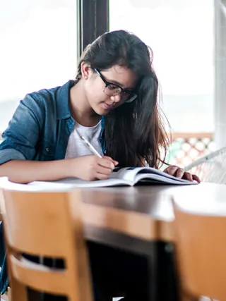 Business and economics student studying at table