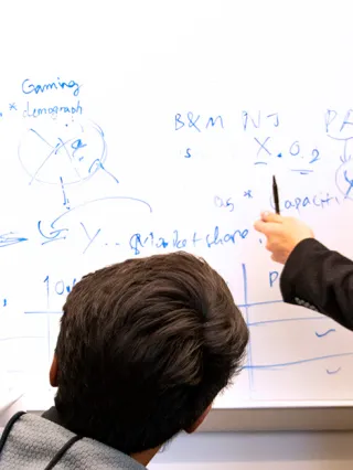 Business analytics students working on a project